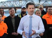 New Labor leader Dean Winter is photographed in front of construction workers in high-vis clothing. Picture supplied