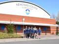 Newstead College students in-front of the new gymnasium sign on campus. Picture suplied